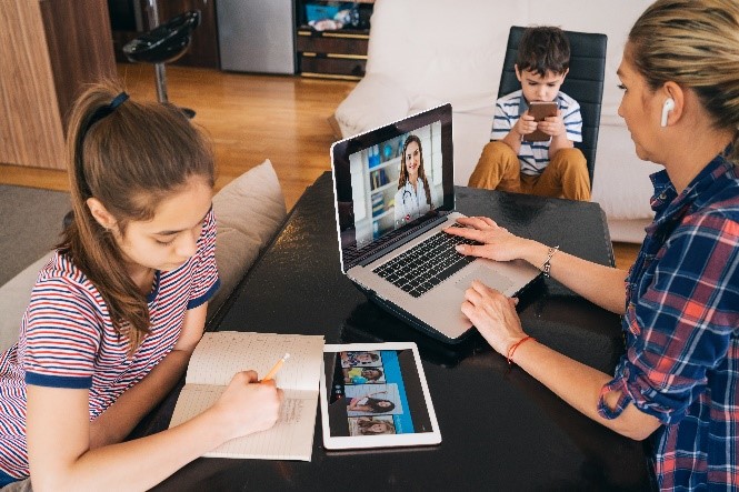 A person and a child using a computer Description automatically generated